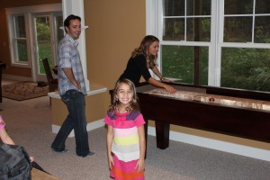 Family Fun on a shuffleboard table