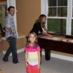 Family Fun on a shuffleboard table